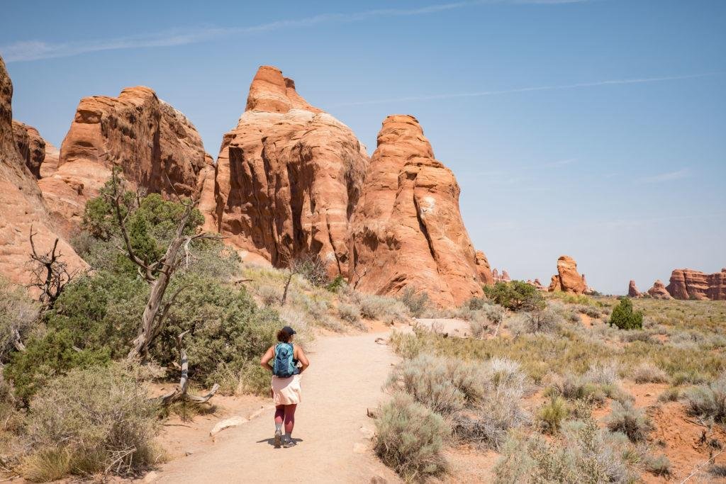 woman hiking in devil's garden in arches national park