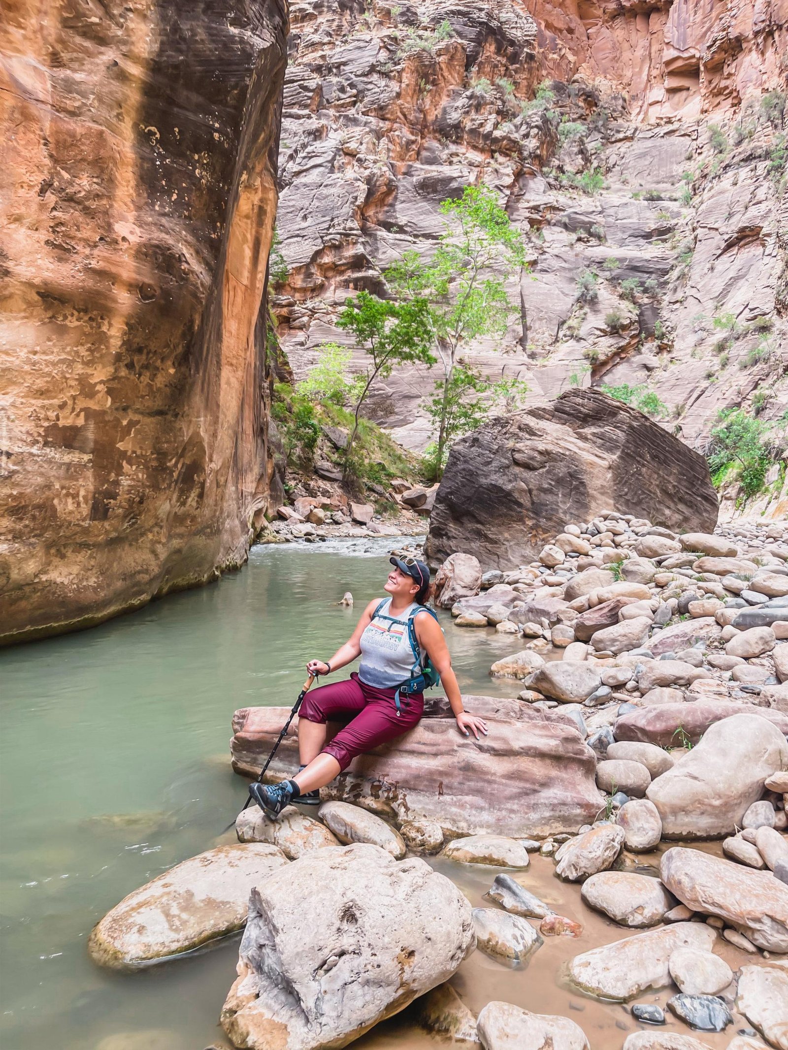 sitting on the rocks in the narrows in zion national park