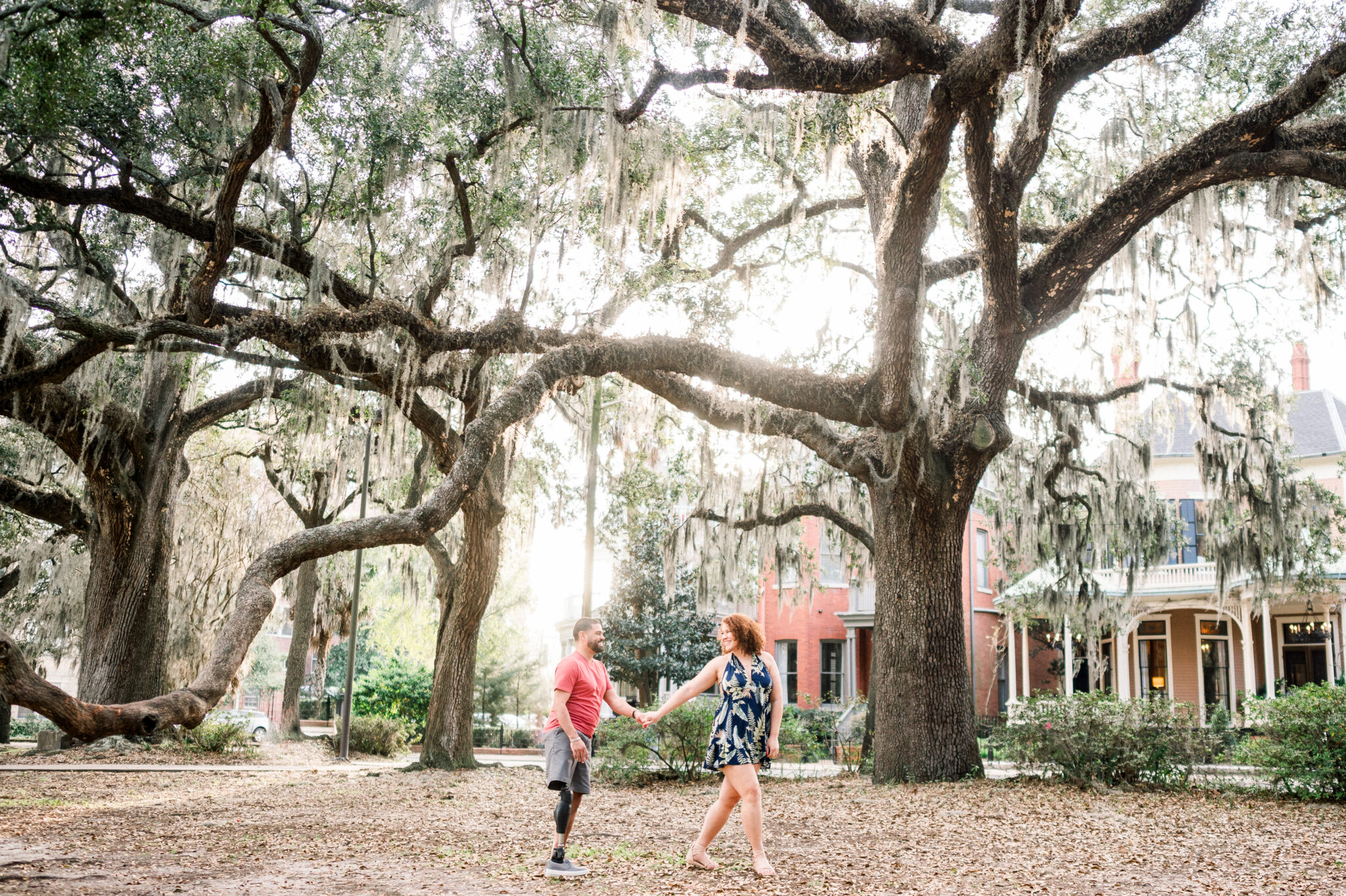 carlos and I holding hands in forsyth park in savannah