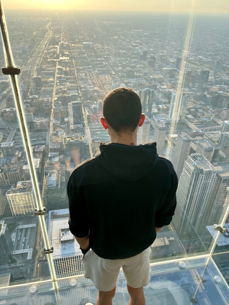 Standing on The Ledge at Willis Tower and looking toward the Chicago Skyline with the sunset in the far background
