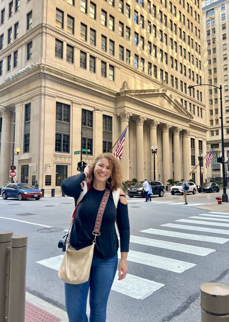 a photo of me in the corner of LaSalle Street and Jackson Boulevard with the Federal Reserve Bank of Chicago Building in the background