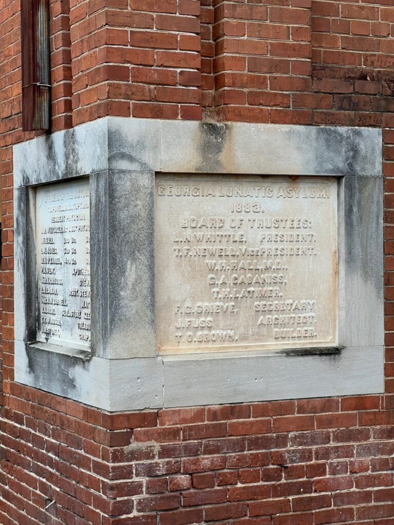 Original cornerstone at Central State Hospital inscribed with "Georgia Lunatic Asylum," the institution's first name when it opened.