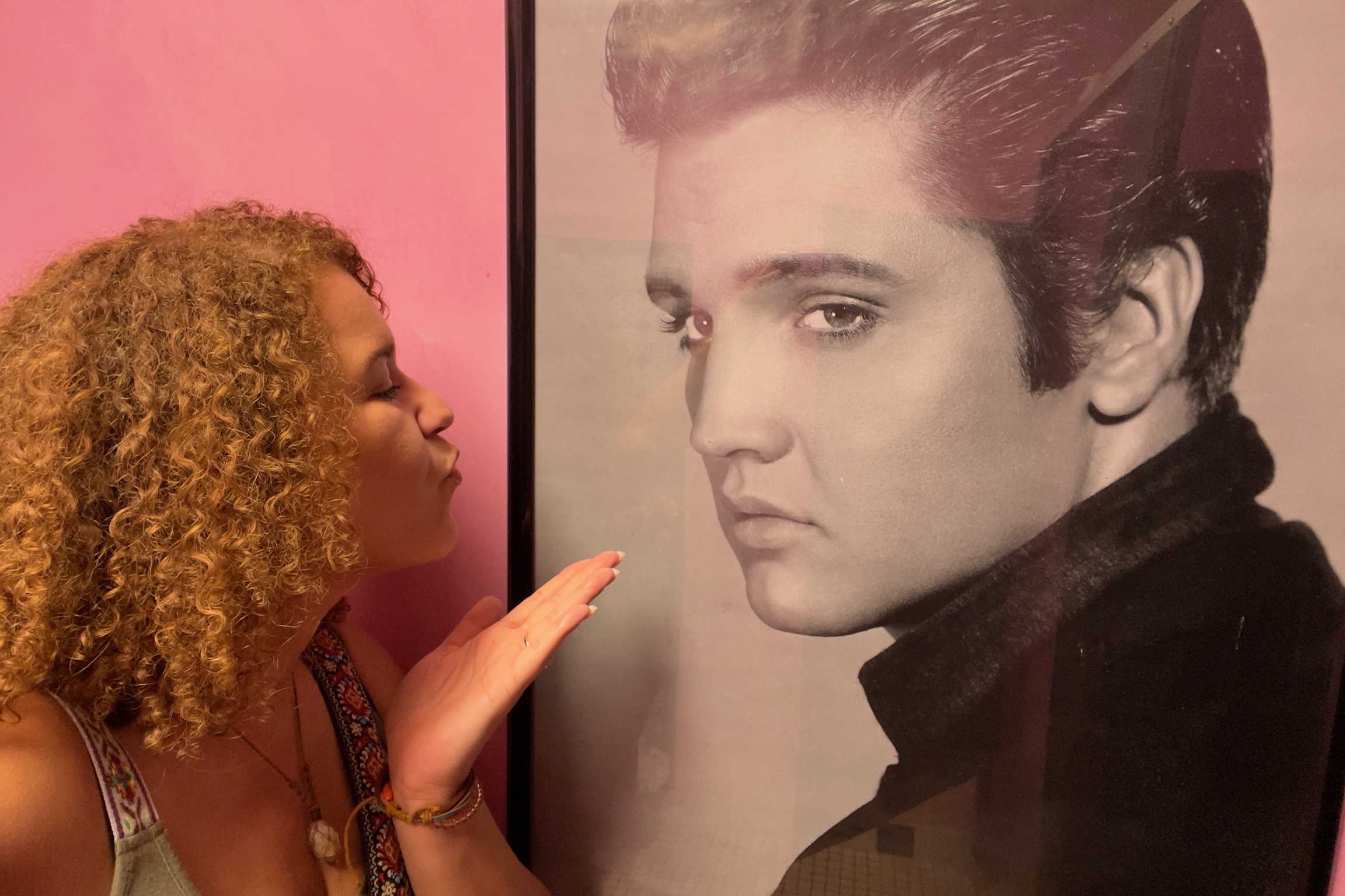 Throwing a kiss at an Elvis picture inside Coney Island Drive Inn in Brooksville, Florida, a retro drive-in full of vintage Americana.